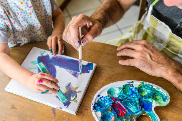 istock Father and son painting together 1143963846