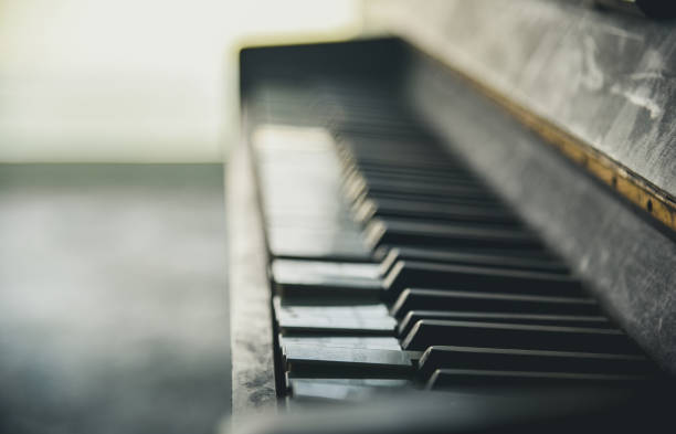istock Piano keyboard background with selective focus. Warm color toned image 1143964619