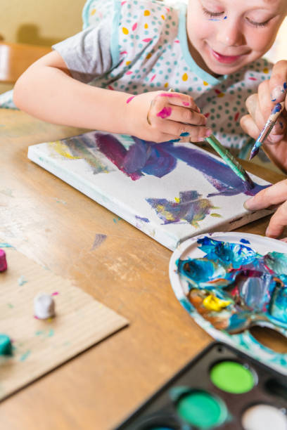 istock Father and son painting together 1143964633