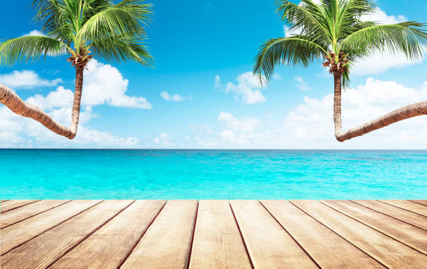 istock Blurred blue sky and sea with bokeh light and white wooden table background 1143964807