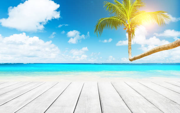 istock Blurred blue sky and sea with bokeh light and white wooden table background 1143964836