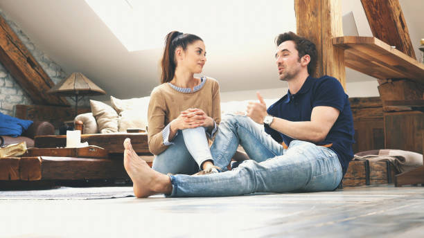 istock happy couple talking to each other at home 1143967349