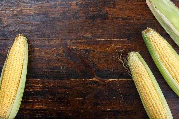 istock young corn heads on a wooden table. 1143967375