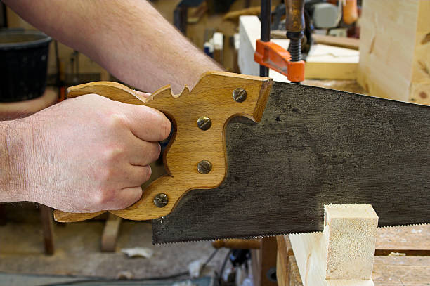 istock Carpenter Using A Handsaw To Cut Softwood 114396806