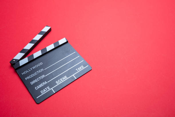 Cinama film concept. Movie clapper board on red color background, copy space