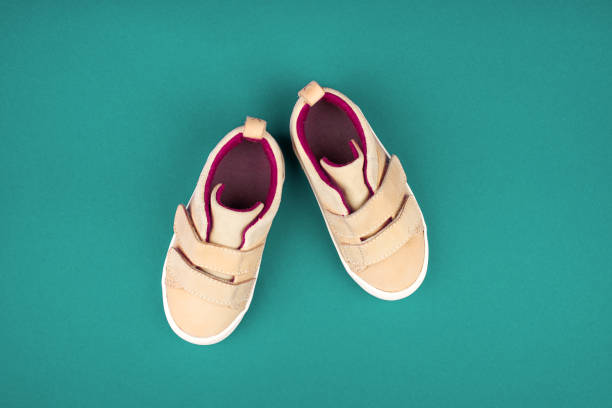 istock Sneakers on a green background, top view, summer shoes. 1143972917