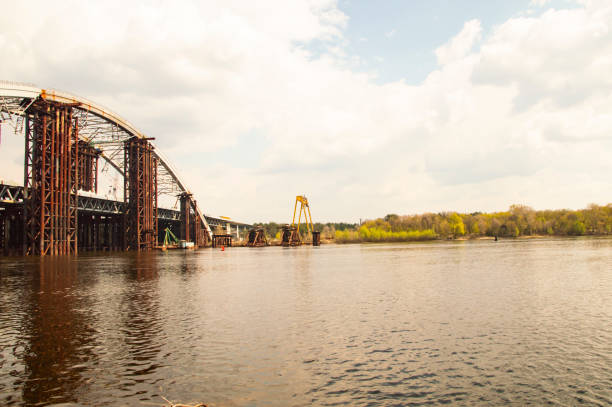 istock Bridge under construction across the Dnieper River in Kiev Ukraine 1143973012