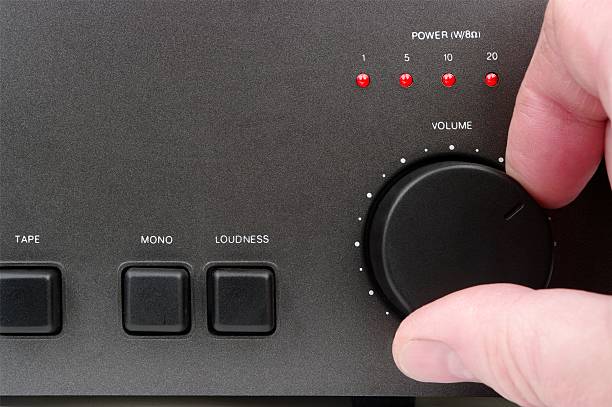 Hand Adjusting Volume Control  volume knob stock pictures, royalty-free photos & images