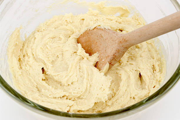 istock Cake Mix In Glass Bowl With Wooden Spoon 114397314