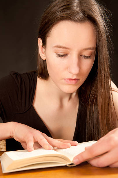 istock Pretty young woman reading a book 114397486