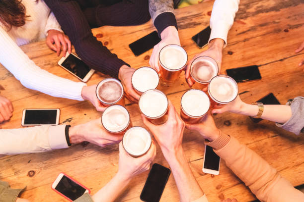 istock Friends drinking and toasting beer at pub 1143976523