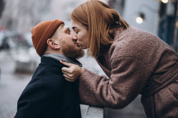 Adult loving couple kissing on a street stock photo