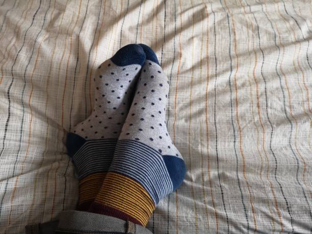 istock Colorful socks on bedspread relaxing weekend concept 1143978462