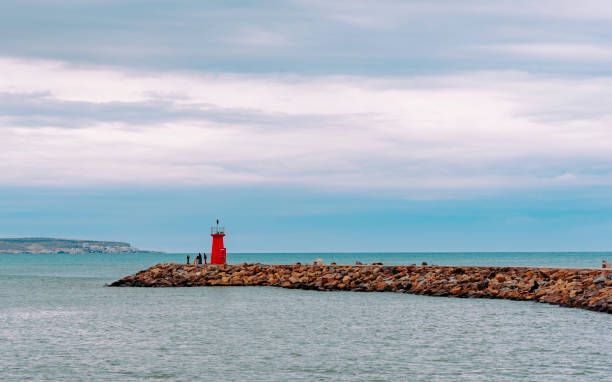 istock Lighthouse at the end of the breakwater 1143979422
