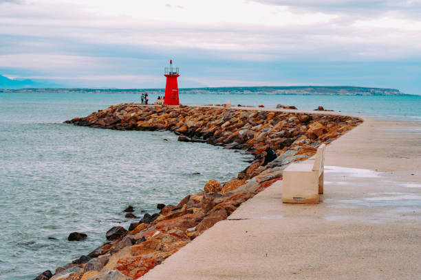 istock Lighthouse at the end of the breakwater 1143979441