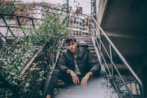 istock Handsome young man standing on stairs portrait 1143979560