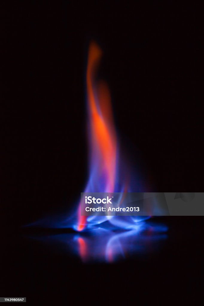 Flame of burning alcohol on black background. Gas flame. Black background. Abstract blaze fire flame texture background. Beautiful flame of burning alcohol, great design for any purposes. Abstract blaze fire flame texture background. Gas flame. Black background. Flame Stock Photo