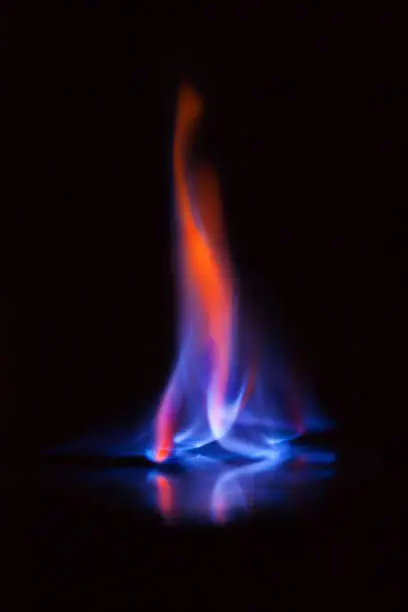 Photo of Flame of burning alcohol on black background. Gas flame. Black background. Abstract blaze fire flame texture background.