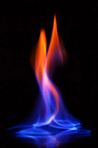 Photo of Flame of burning alcohol on black background. Gas flame. Black background. Abstract blaze fire flame texture background.