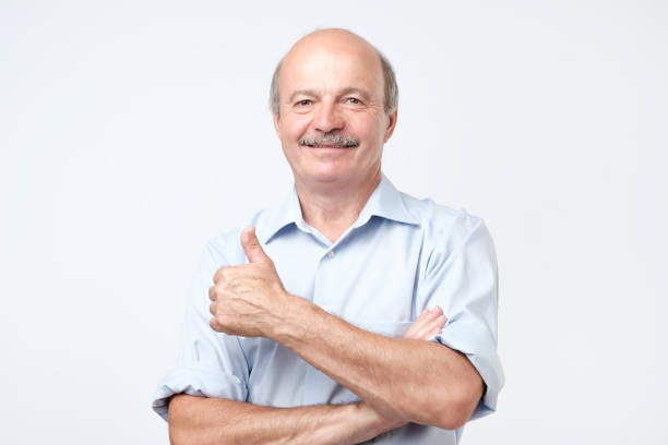 istock Portrait happy middle aged man showing thumb up. 1143981514