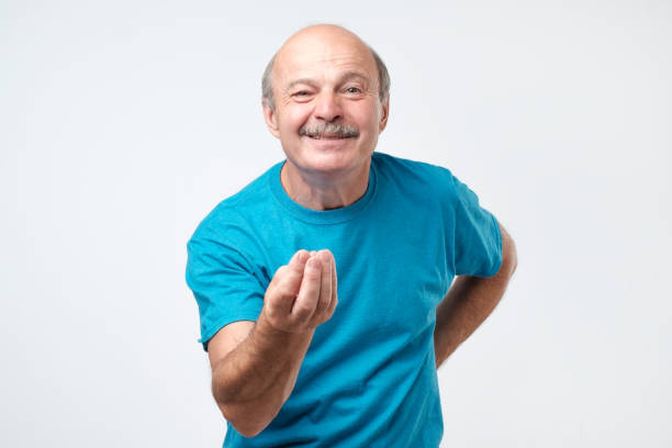 Man with raised hand and showing italian gesture trying to explain his opinion Cute bearded european male standing with raised hand and showing italian gesture trying to explain his opinion. Brother proves his point of view mediterranean ethnicity stock pictures, royalty-free photos & images
