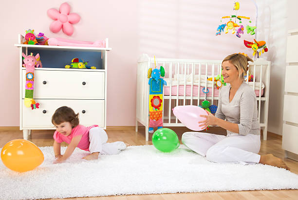 A cozy, pastel-themed children's room with a house-shaped wardrobe, plush toys, and a giraffe stool. The decor features soft beige, pink, and mint colors, creating a warm and inviting atmosphere.