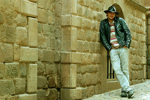 istock Young man leaning on the Inca wall 114398281