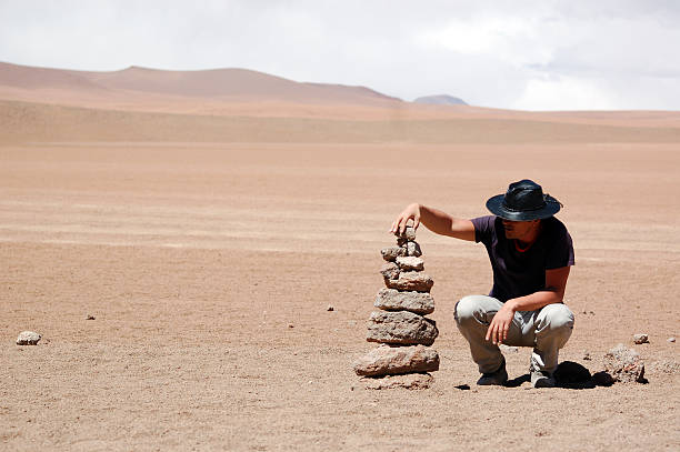 istock Man building stone sign in desert 114398314