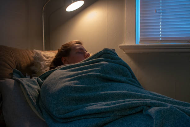 istock woman feeling freeze and wrap up in a blanket 1143983751