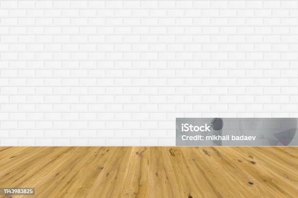 Empty Room With Brown Wooden Floor And White Metro Tiles Wall Empty Loft Room For Design Interior Stock Photo - Download Image Now