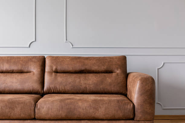 istock Leather sofa on a grey wall in a living room interior 1143984806