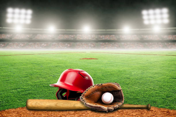 Baseball Bat, Helmet, Glove and Ball on Field in Outdoor Stadium With Copy Space Baseball helmet, bat, glove and ball on field at brightly lit fictitious outdoor stadium. Focus on foreground and shallow depth of field on background and copy space. Stadium created in Photoshop. base sports equipment photos stock pictures, royalty-free photos & images