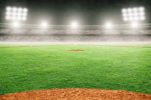 Baseball field at brightly lit fictitious outdoor stadium. Focus on foreground and shallow depth of field on background and copy space. Stadium created in Photoshop.