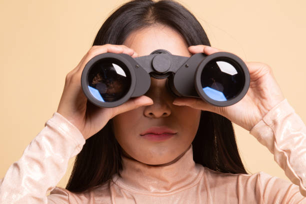 istock Young Asian woman with binoculars. 1143986870