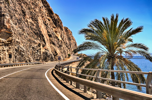 Driver's view of scenic coastal highway between the Mediterranean cities of Almeria and Aguadulce in southern Spain.