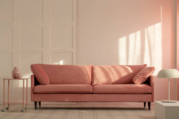 istock Pastel pink couch in white living room interior, copy space on empty wall 1143989006
