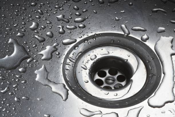 istock Water Drops Around Plughole In Stainless Steel Sink 114398922