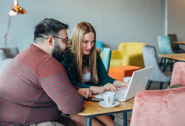 istock Friends working on laptop in cafe 1143991484