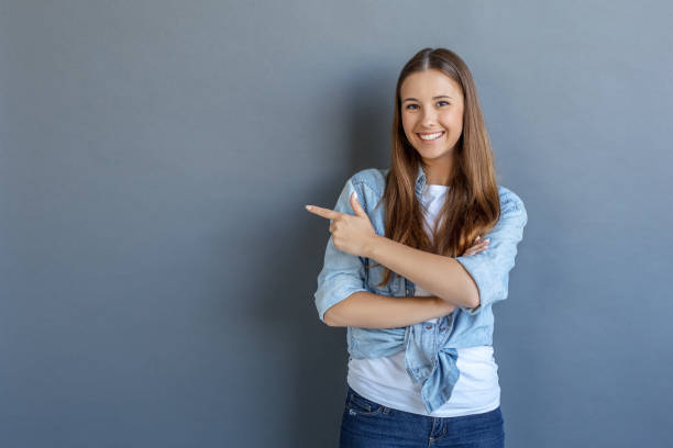 istock Young woman free style isolated on grey 1143998171