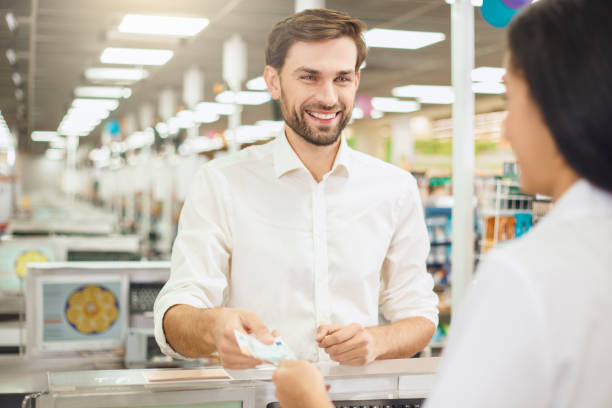 Man buying food products in the supermarket shopping stock photo