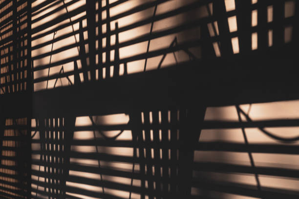 istock Shadow of a spiral staircase cast upon a rendered concrete wall 1143998806