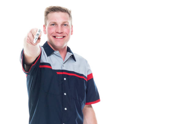 istock Young handsome male mechanic standing on white background - pointing 1144000709