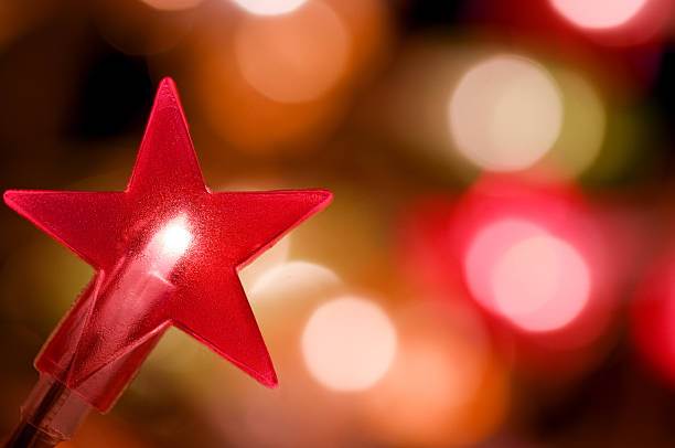 istock Star shaped christmas light with defocussed background 114400137