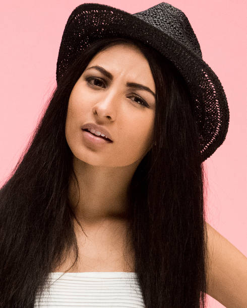 istock Beautiful female on pink background and is feeling confused 1144001589