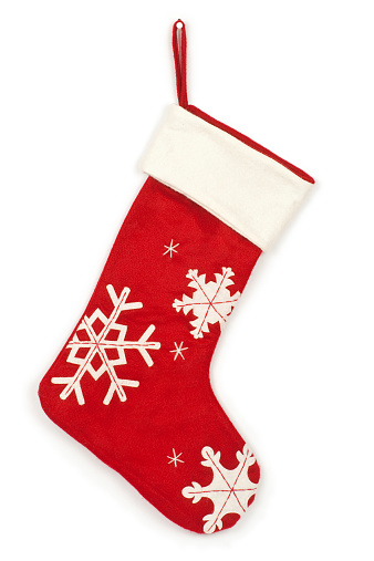 Red Christmas stocking with gifts and decoration. Traditional Xmas celebration concept