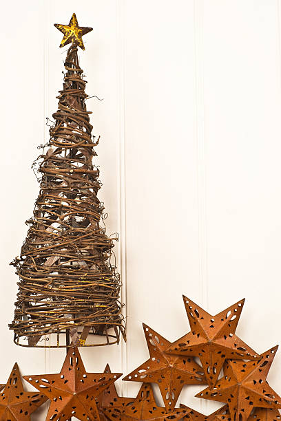 istock Metal christmas tree with rusty star decorations against panelled wall 114400195