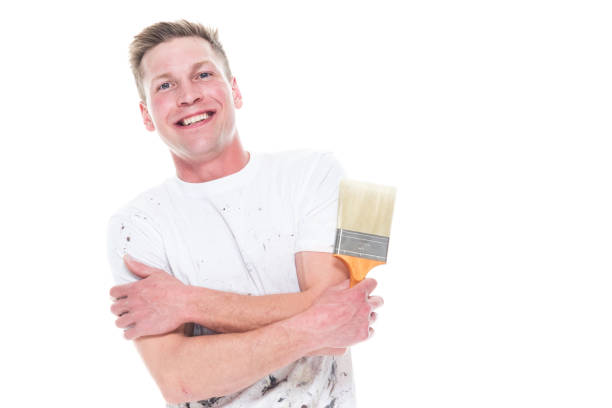 istock Young attractive male painter standing on white background - smiling 1144002670