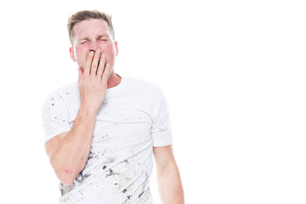 istock Young attractive male painter standing on white background - tired 1144002700