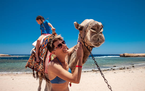 istock Daughter and Mother Using a Camel on Vacations in Egypt 1144002823