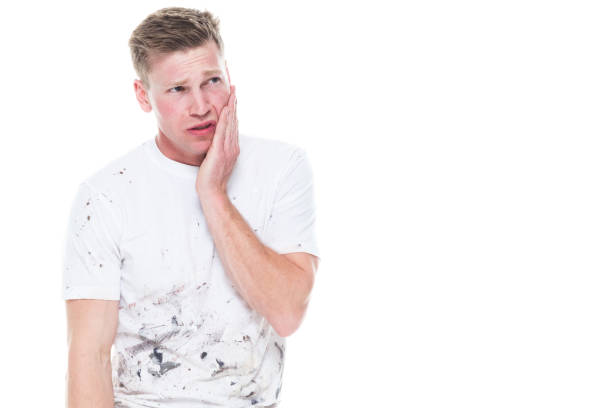 istock Young attractive male painter standing on white background - sadness 1144002906
